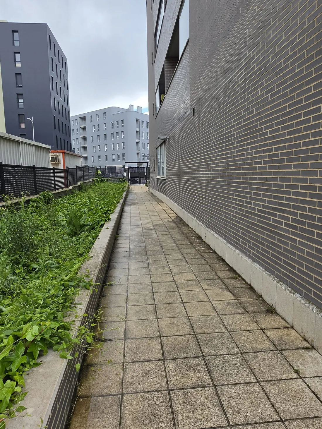 Acera exterior con suelo de pavimento entre dos edificios residenciales de Vitoria